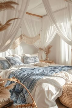 a bed with blue and white linens in a bedroom next to a wicker basket