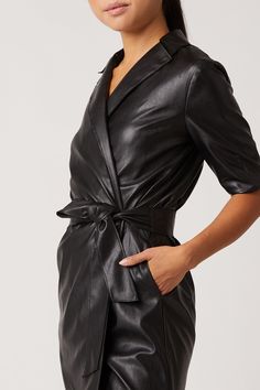 Our Robin Vegan Leather Dress, is a sultry trench dress that signifies everything chic. This bold black mini has 3/4 length sleeve detail, is made of our Vegan Leather with Japanese Technology, and hits above the knee in length. 100% Vegan Leather - 100% Polyurethane Dry Clean Only Made in USA Model is 5'11 and wearing size S Belted Knee-length Mini Dress For Work, Knee-length Belted Mini Dress For Work, Formal Short Sleeve Mini Dress With Belt, Formal Short Sleeve Belted Mini Dress, Sleek Mini Length Blazer Dress For Work, Spring Belted Black Blazer Dress, Chic Belted Knee-length Mini Dress, Belted Black Blazer Dress For Spring, Chic Knee-length Belted Mini Dress