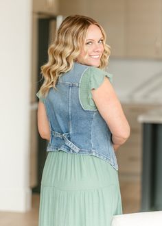 The Denim Sleeveless Button Up Vest is a layering piece that looks good with just about anything! Designed with a classic v-neck, a button front closure, a slim cut, and an adjustable back for the perfect fit. Pair this vest with your favorite denim skirt for an on trend denim on denim look, or layer over your favorite sundress! Style: Sleeveless SIZING TIPS Fit | Fitted Stretch | Mid-Stretch Our Models wore her true to size medium. Sundress Style, Blue Jean Vest, Denim On Denim Looks, Denim On Denim, Spring Capsule Wardrobe, Denim Midi Skirt, Staple Pieces, Blue Jean, Layering Pieces