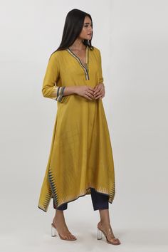 Mustard yellow block print tunic with a V neckline and an asymmetric hem.
Components: 1
Neckline: V Neck
Sleeve Type: Three-quarter
Fabric: Modal
Color: Yellow
Other Details: 
Note: Pant worn by the model is not for sale
Occasion: Puja, Work - Aza Fashions Fitted Yellow Bohemian Kurta, Mustard Kurta For Women, Multicolor Block Print Tunic Kaftan, Yellow Printed V-neck Kaftan, Festival Block Print V-neck Kaftan, Print Tunic, Womens Tunics, Asymmetric Hem, Mustard Yellow