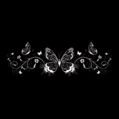 a black and white wallpaper with some butterflies on it's back side, in the dark