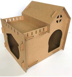 an open cardboard box with holes in the front and inside that are cut out to look like a house