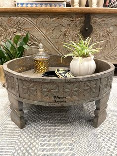 a potted plant sitting on top of a metal tray next to a candle holder