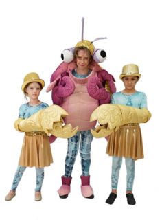 three children in costumes standing next to each other