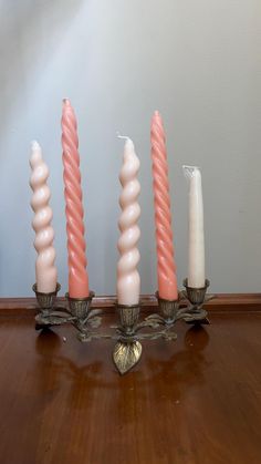 four candles are lined up on a table