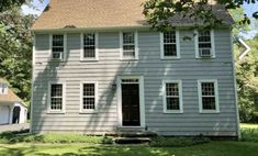 a gray house with white trim and windows