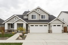 a large house with two garages in the front yard