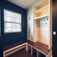 an empty room with some shelves and benches