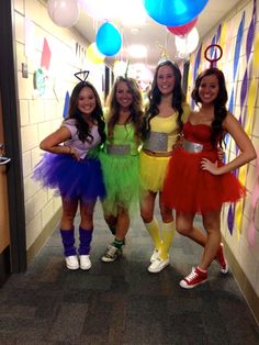 three girls in costumes are posing for the camera