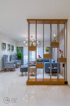 a living room filled with furniture next to a wall covered in mirrors and plants on top of it