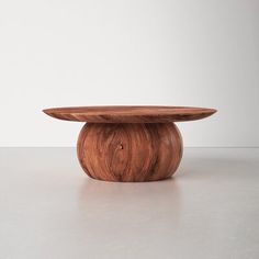 a wooden table sitting on top of a white floor