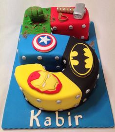 a birthday cake made to look like batman, captain america, and iron man symbols