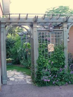 an outdoor garden with lots of plants and flowers