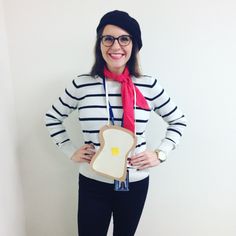 a woman wearing glasses and a red scarf holding a piece of bread