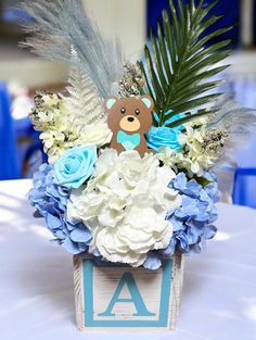 a blue and white centerpiece with a teddy bear