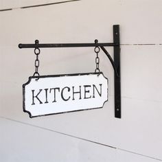 a kitchen sign hanging from the side of a wall