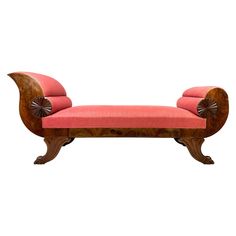 a wooden bench with pink upholstered fabric on it's back and arms