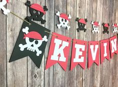 pirate banner with skull and crossbones hanging on the wall next to wooden planks