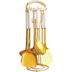 a golden kitchen utensil holder with white handles and gold spatulas on it