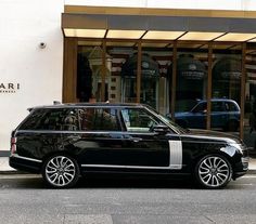 a black and white car parked in front of a building