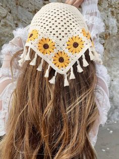 a woman wearing a white hat with sunflowers on it