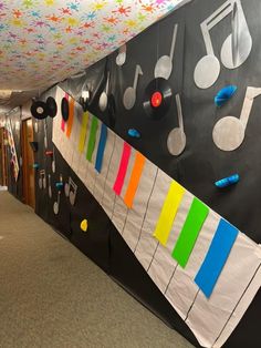 an office hallway decorated with musical instruments and music notes on the wall, along with colorful streamers