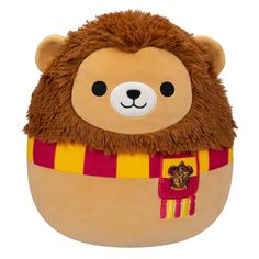 a stuffed animal with a red and yellow scarf around it's neck, on a white background