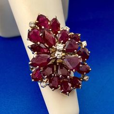 * Exquisite Vintage 14K Yellow Gold Ruby Diamond Cluster Statement Cocktail Ring * Ring Size: 4.75 * Top of Ring measures: 1 1/4" x 1" * Height: 1/2" * Eighteen Marquise, Oval and Pear shaped Rubies measure: approximately 6.5 mm x 4 mm, 5mm x 3mm, 5 mm x 4.25mm * Seven round Diamonds measure: approximately 1.75 mm * Gram Weight: 8.0 tgw * Marked: 14K 1040 * Condition: Great * Can be sized for an additional fee * Unknown if rubies are natural or lab-created * (G175) 5% Restocking Fee    Exported By ExportYourStore :) Formal Cluster Ruby Ring Stamped 14k, Ruby Diamond, Diamond Cluster, Ring Ring, Cocktail Ring, Cocktail Rings, Rings Statement, Pear Shaped, Round Diamonds