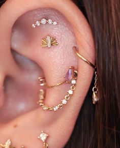 an ear with several different types of piercings on it