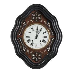 an ornate clock with roman numerals on the face and numbers in black, gold and white