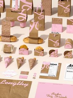 some brown and pink paper bags on a table