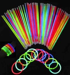 glow sticks and tubes are arranged on a black background