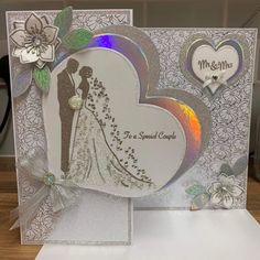 a wedding card with a bride and groom in the middle, on top of a table