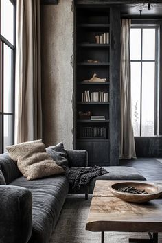 a living room filled with furniture and bookshelves next to a window covered in curtains