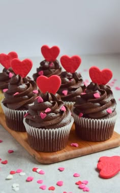 cupcakes with chocolate frosting and hearts on top