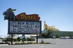 a large sign in front of a store called dune's ben blue and gags gals