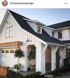 a white house with black roof and windows