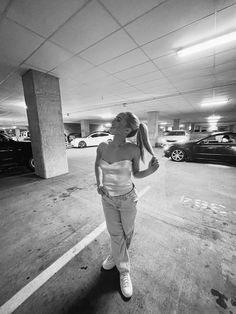 black and white photograph of woman in parking garage