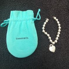 Original/Authentic Tiffany & Co. Return To Tiffany Heart And Bead Ball Bracelet. 925 Fine Sterling Silver. Size Is For Small/Medium Wrist. Used And In Very Good/Like New Condition As It Was Never Used. Purchased Years Ago At Tiffany & Co. Store In California, But Item Is Still Sold At T&C Stores Today (At Over $400). Recently Polished Myself (See Pic Of Items I Polished Using T&C Polish), But Buyer Can Have It Professionally Cleaned At Any Tiffany & Co. Store. No Trades. Serious Buyers Only - Pl Elegant Sterling Silver Beaded Bracelet With Heart Charm, Elegant Beaded Bracelet With Heart Charm For Valentine's Day, Elegant Sterling Silver Beaded Bracelets With Heart Beads, Elegant Heart Bracelet With Round Beads For Valentine's Day, Elegant Beaded Heart Bracelet For Valentine's Day, Elegant Heart Bracelet For Valentine's Day, Elegant Valentine's Day Heart Bracelet With Round Beads, Elegant Beaded Bracelet With Heart Charm For Wedding, Elegant Silver Beads Jewelry For Valentine's Day