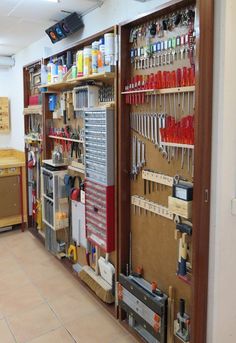 a room filled with lots of tools and shelves on the wall next to each other