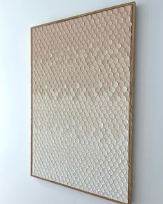 a painting hanging on the wall in an empty room with white walls and flooring