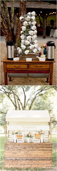 a wooden table topped with white plates and cups next to a tree filled with potted plants