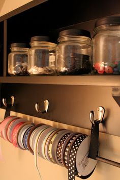 a shelf filled with lots of jars and magnets