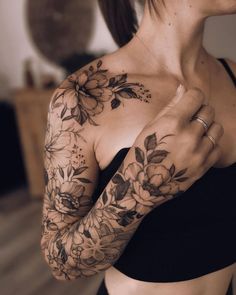 a woman with flowers on her arm and chest is shown in the instagramr