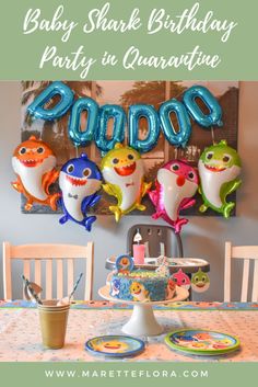 a baby shark birthday party in quarance with balloons and plates on the table