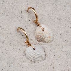 Easy, breezy, and a little bit beachy - the perfect earring when you want better than basics. ABOUT THE NAME Cortez Beach is one of the last remaining fishing villages on Florida's southwest Gulf coast. Just pull off the side of the road and take a quick walk through the tall trees and coastal grasses to the white sand beach. MATERIALS Cross-barred Venus shells on with 14k gold-filled hoops Every stone, shell, and handmade glass piece is unique, which means that each charm is too. You can expect Bohemian Nickel-free Hoop Earrings For Beach, Single Dangle Earring For Beach, Summer Beach Dangle Hoop Earrings, Shell Dangle Hoop Earrings For Beach, Pierced Dangle Earrings For Beach, Dangle Earrings For The Beach, Bohemian Shell Hoop Earrings For Beach, Bohemian Shell Earrings For Beach, Summer Beach Shell Hoop Earrings