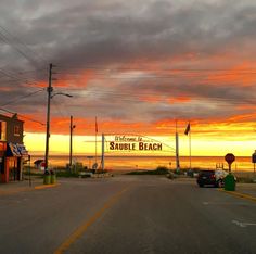 an empty street in front of the ocean with a sign that says sauble beach