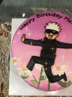 a birthday cake that is decorated with the image of a man in a black suit