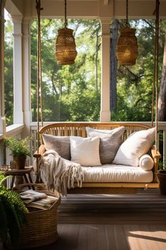 a porch swing with pillows on it