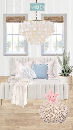 a white bed sitting under a window next to a potted plant on top of a wooden floor